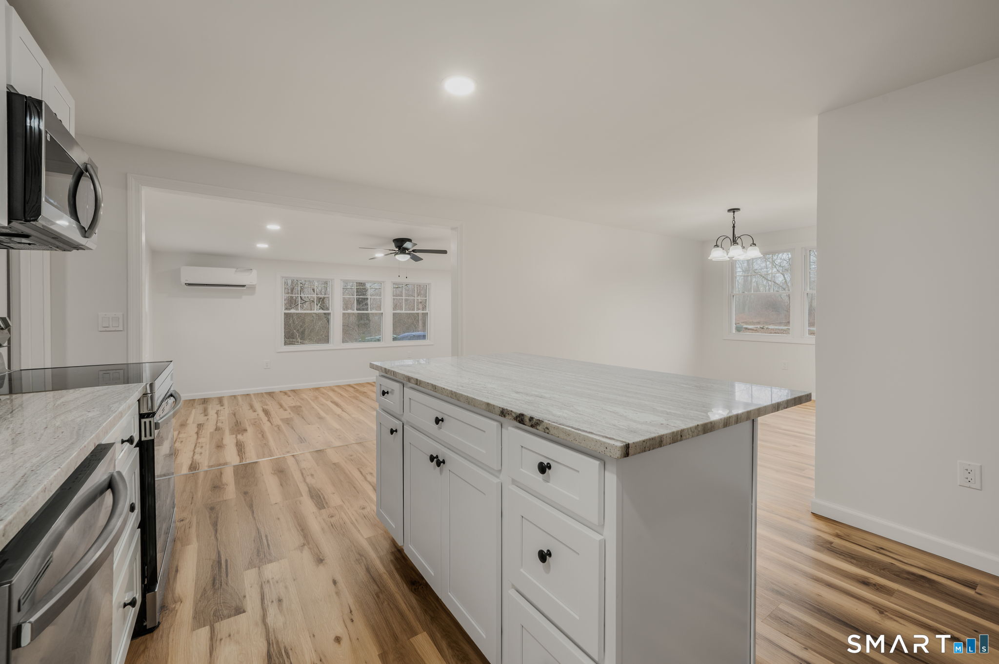 153 Meeting House Lane Ledyard, CT 06339 - Photo 13 of 39 a hall with kitchen island white cabinets and appliances