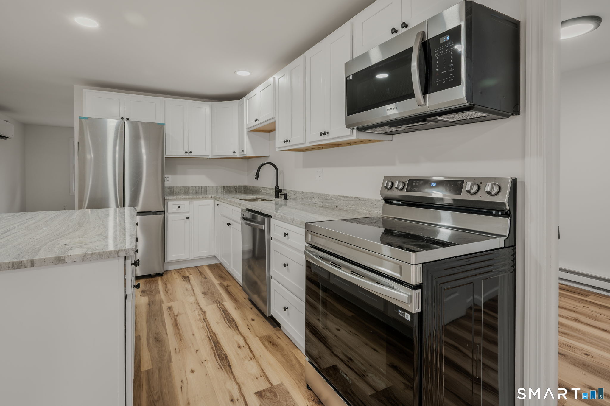 153 Meeting House Lane Ledyard, CT 06339 - Photo 20 of 39 a kitchen with a sink stove and microwave