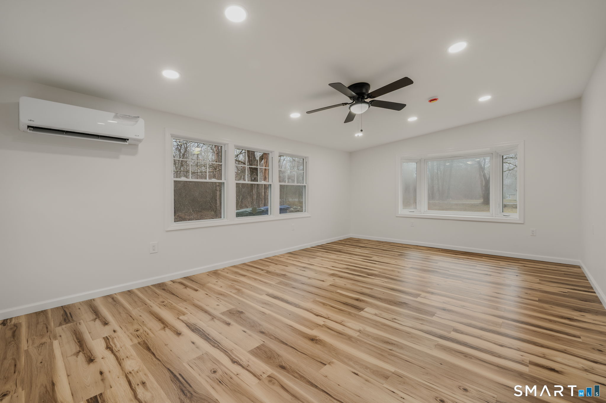 153 Meeting House Lane Ledyard, CT 06339 - Photo 21 of 39 a view of empty room with wooden floor and fan