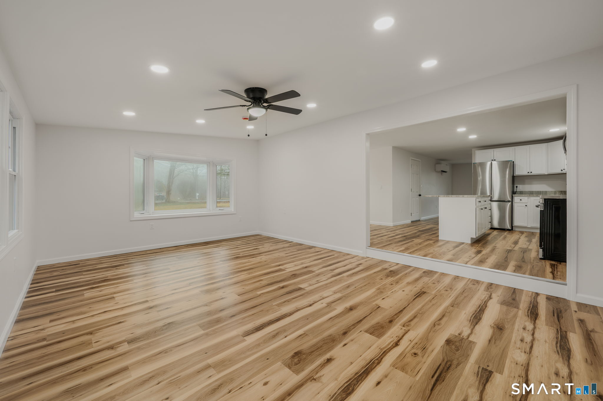 153 Meeting House Lane Ledyard, CT 06339 - Photo 23 of 39 a view of an empty room with a window and wooden floor