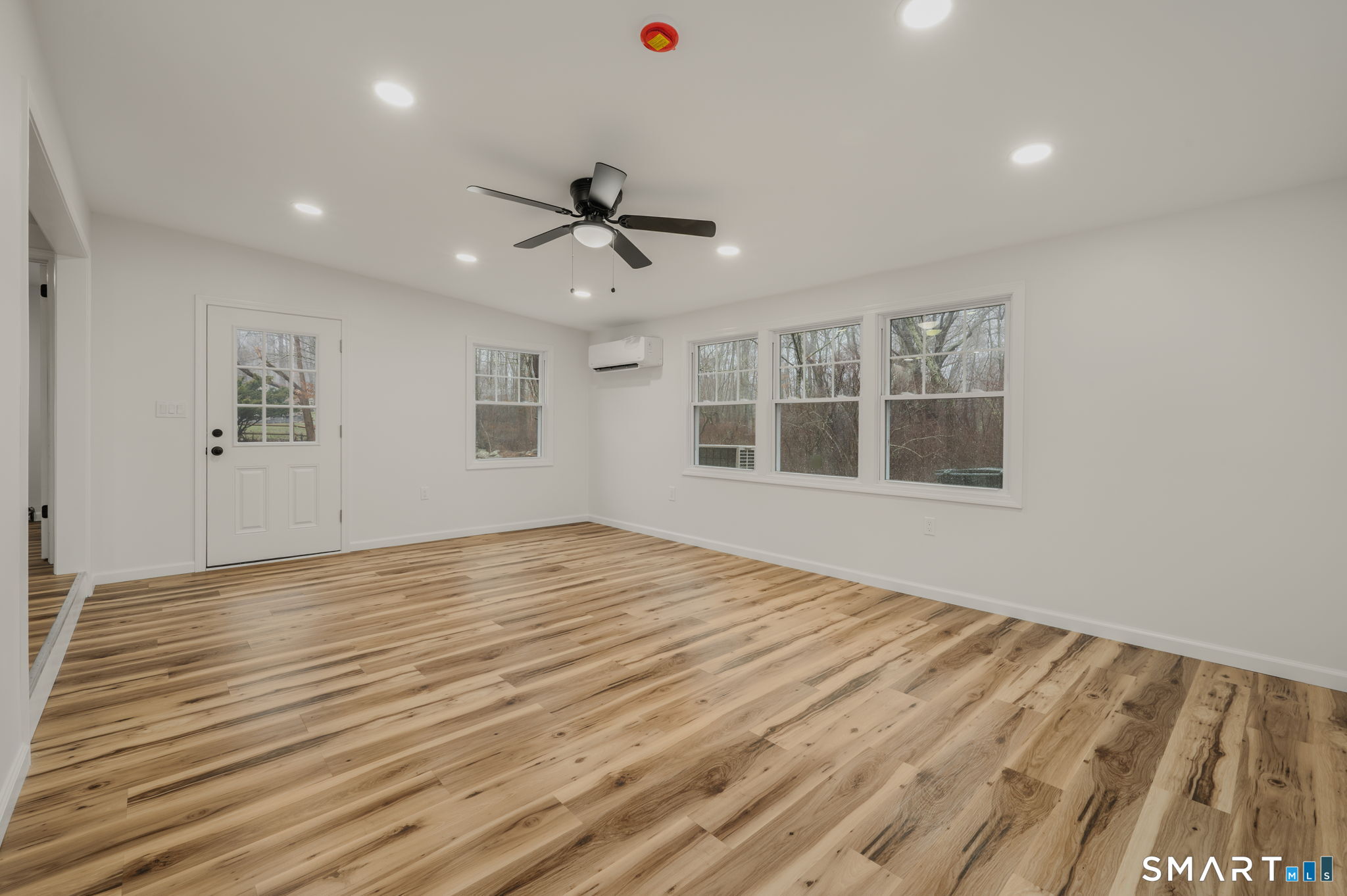 153 Meeting House Lane Ledyard, CT 06339 - Photo 24 of 39 a view of empty room with wooden floor and windows