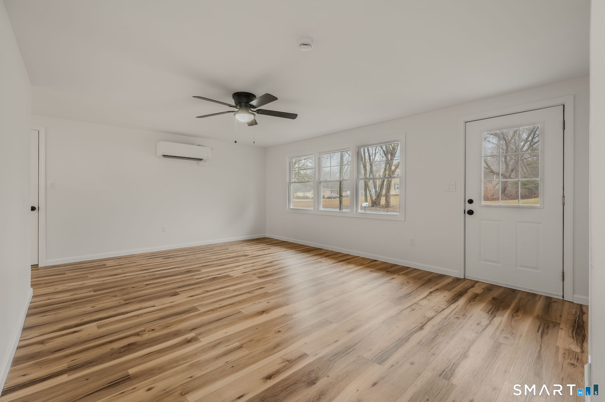 153 Meeting House Lane Ledyard, CT 06339 - Photo 6 of 39 a view of empty room with wooden floor and fan