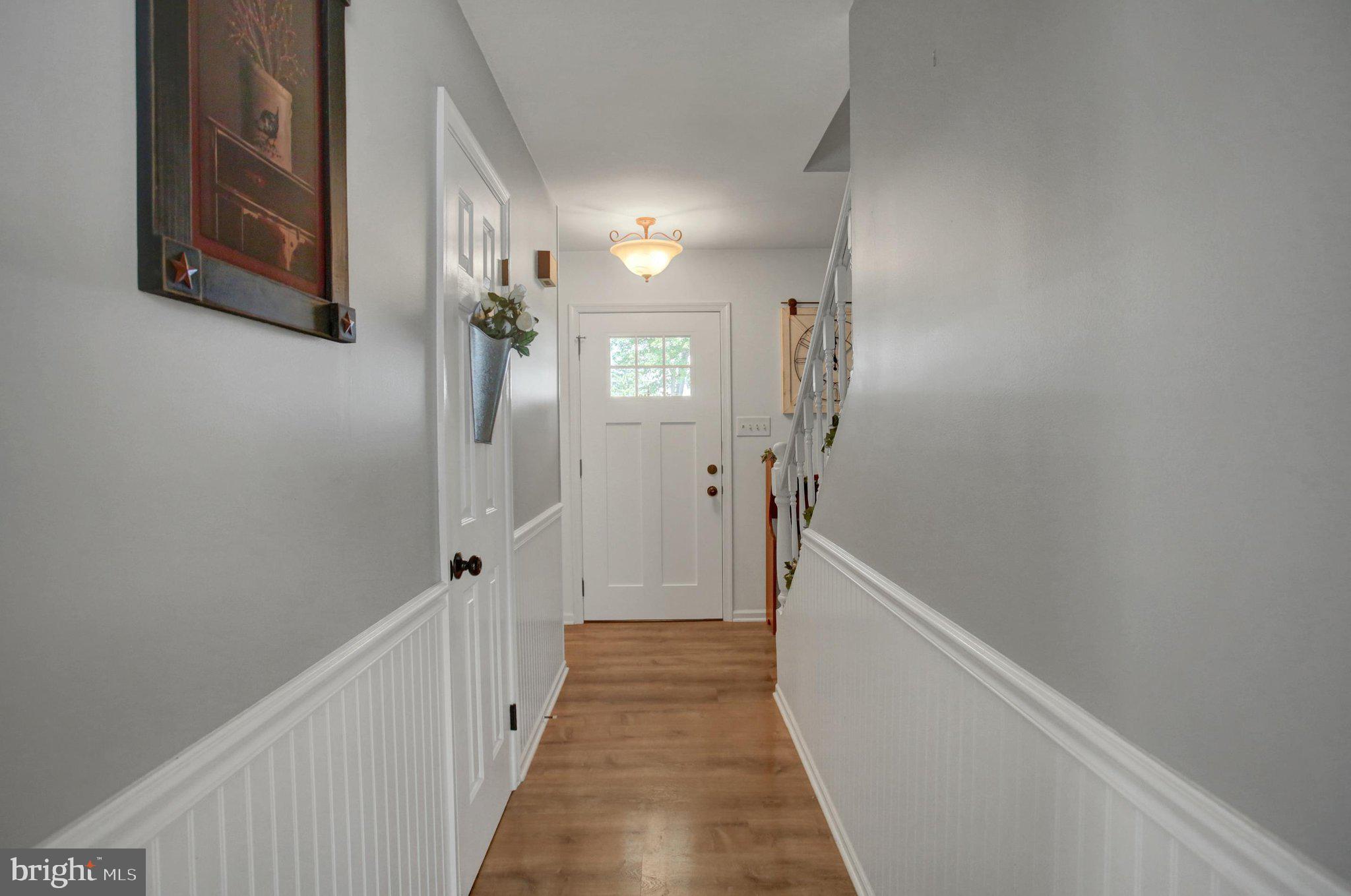 11086 Welsh Run Road Greencastle, PA 17225 - Photo 9 of 63 a view of a hallway with wooden floor and staircase