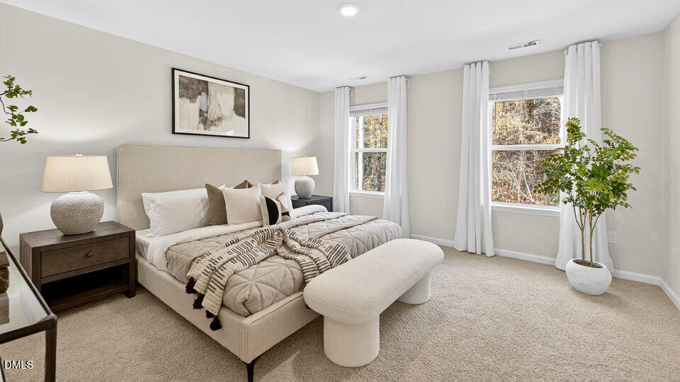 6037 Sodium Street Raleigh, NC 27610 - Photo 14 of 27 a spacious bedroom with two beds and a potted plant