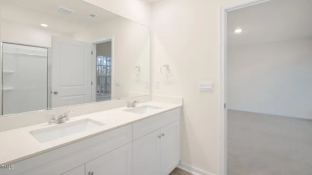 a bathroom with a double vanity sink and mirror