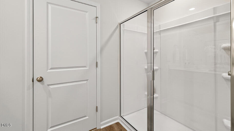 6037 Sodium Street Raleigh, NC 27610 - Photo 20 of 27 a bathroom with a glass shower door