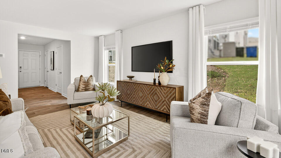 6037 Sodium Street Raleigh, NC 27610 - Photo 5 of 27 a living room with furniture and a flat screen tv
