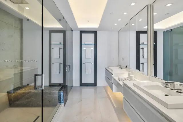 a spacious bathroom with a double vanity sink mirror and shower