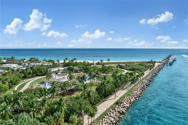an aerial view of a house with a yard and lake view