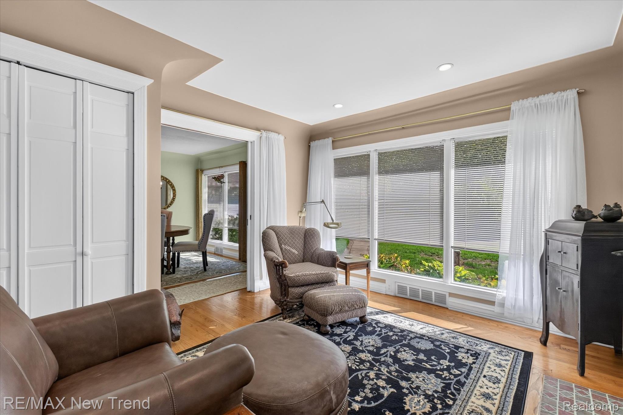 2529 South Commerce Road Walled Lake, MI 48390 - Photo 14 of 66 Recessed ceiling lighting, wood-finish flooring, white bi-fold closet doors, large window array, and an arched doorway