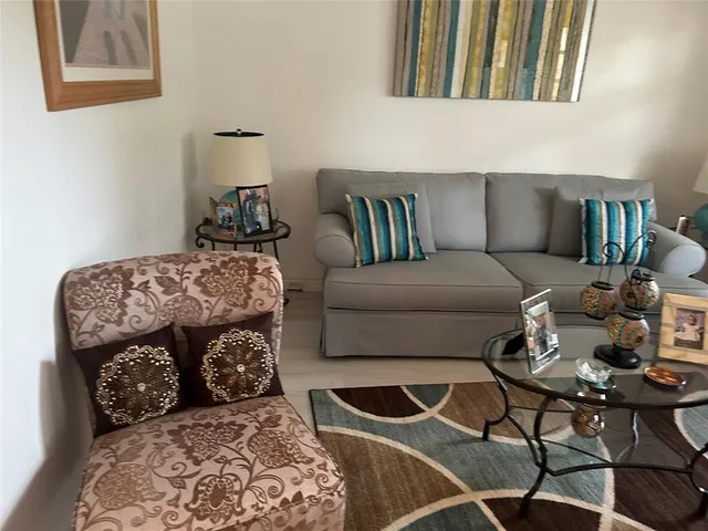 a living room with furniture and a rug