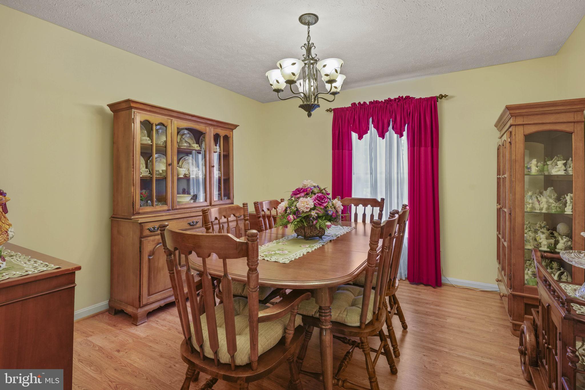 4949 Idlewilde Road Shady Side, MD 20764 - Photo 20 of 31 a view of a dining room with furniture wooden floor and a chandelier
