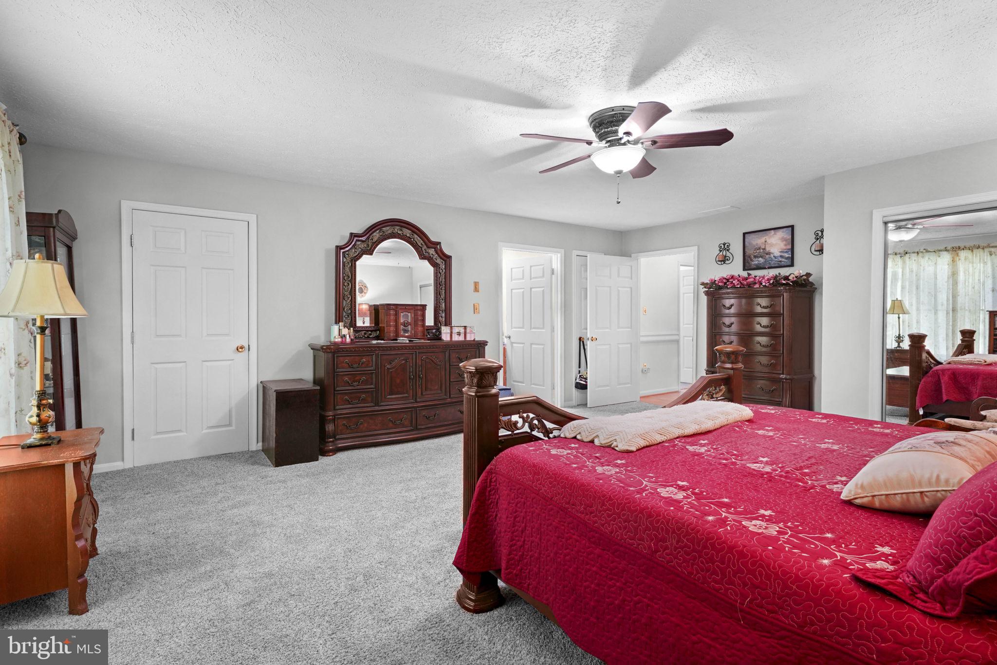 4949 Idlewilde Road Shady Side, MD 20764 - Photo 23 of 31 a bedroom with a bed and a chandelier