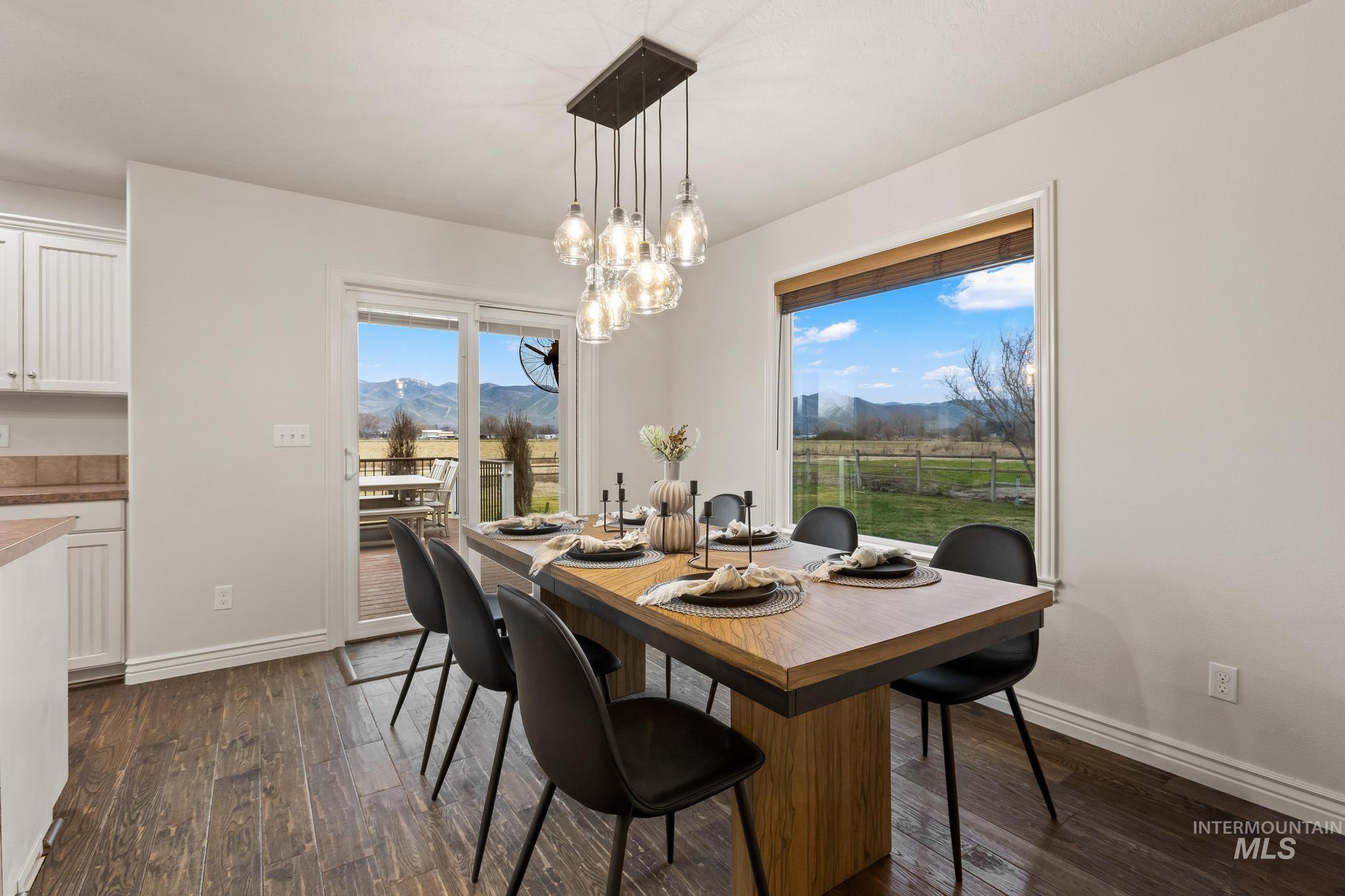 2185 Waterwheel Road Emmett, ID 83617 - Photo 12 of 49 Dining space with a mountain view, dark wood-style floors, and a chandelier