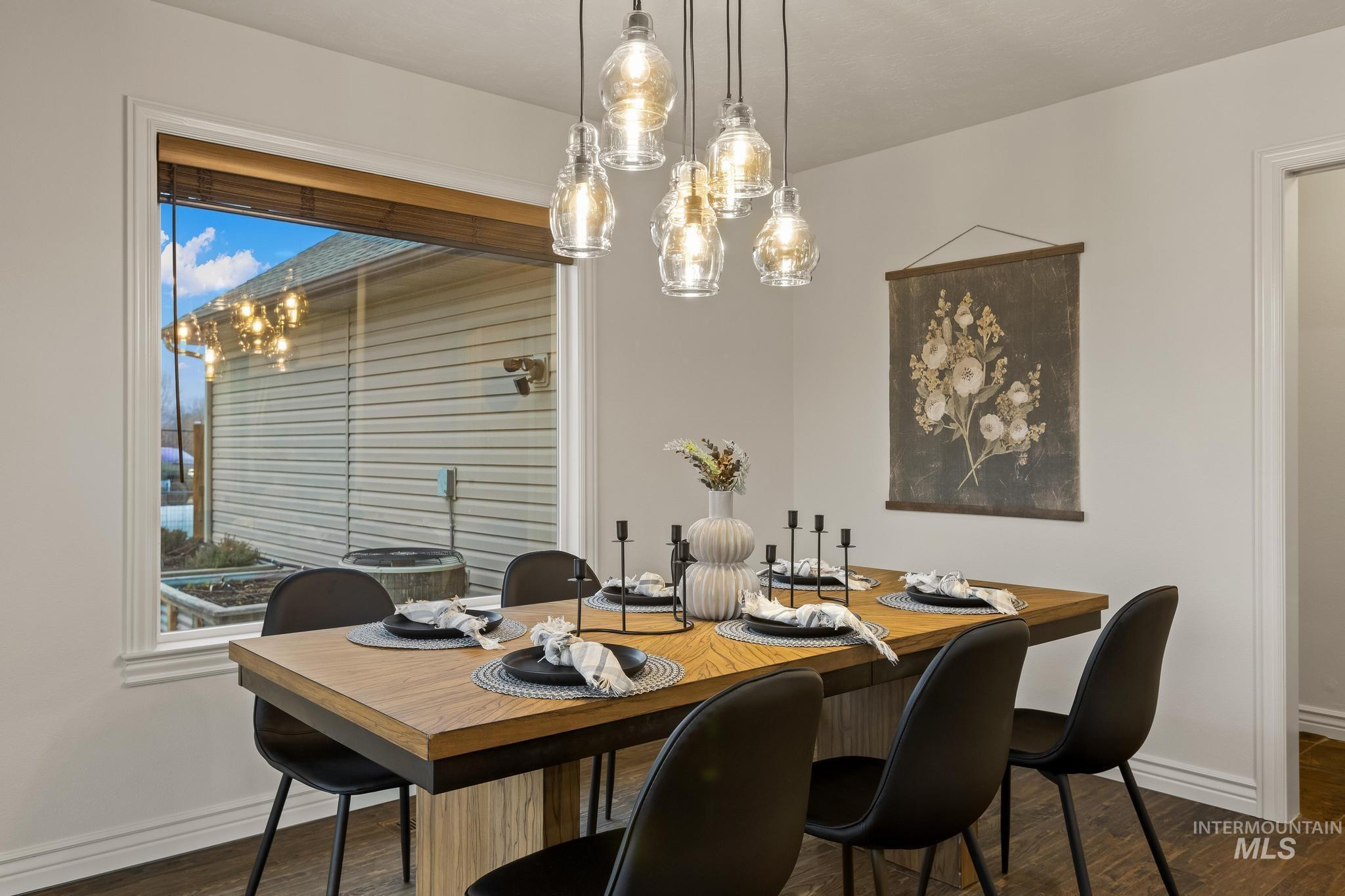 2185 Waterwheel Road Emmett, ID 83617 - Photo 14 of 49 Dining area with dark wood-style flooring and a chandelier