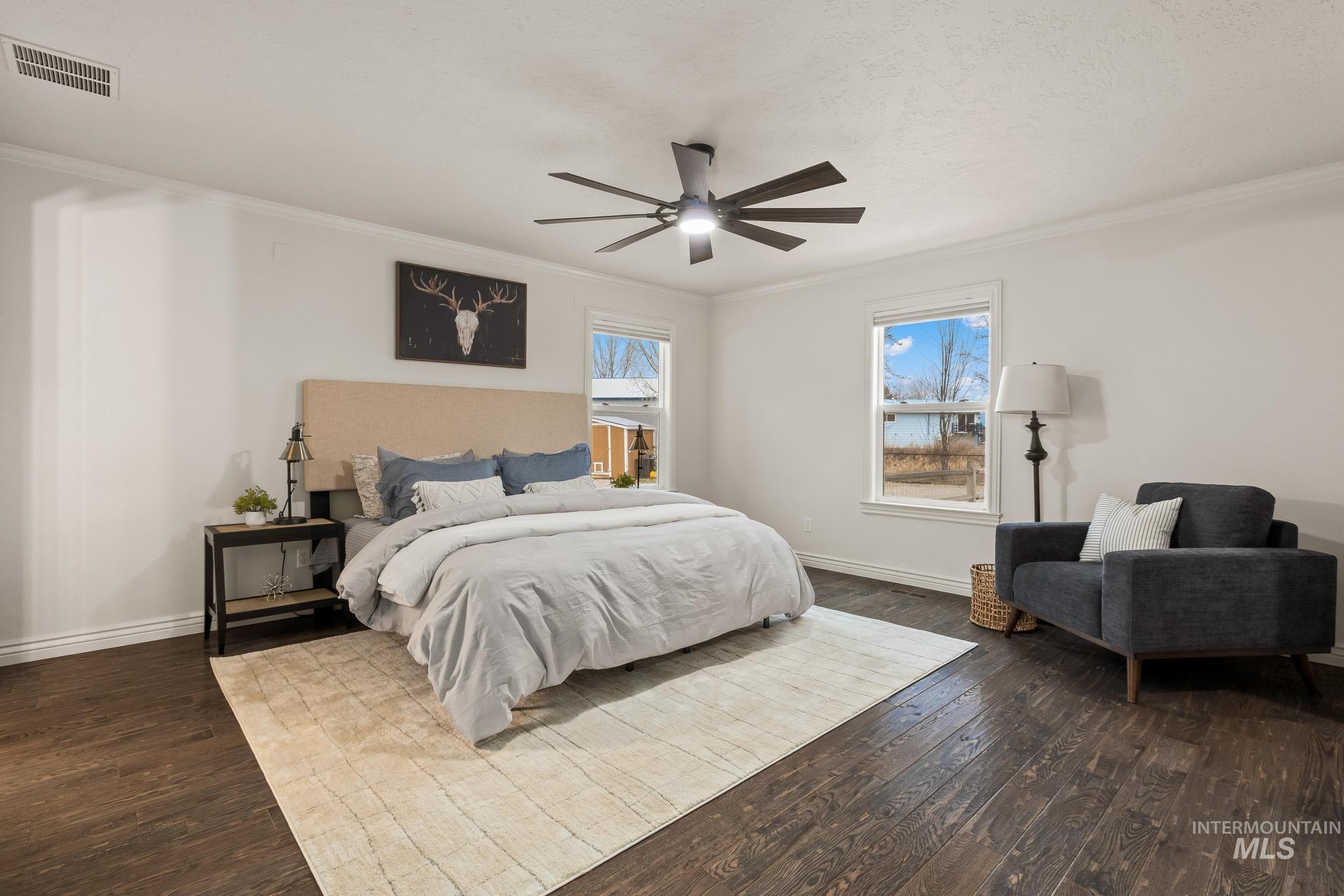 2185 Waterwheel Road Emmett, ID 83617 - Photo 20 of 49 Bedroom with crown molding, a ceiling fan, and dark wood finished floors