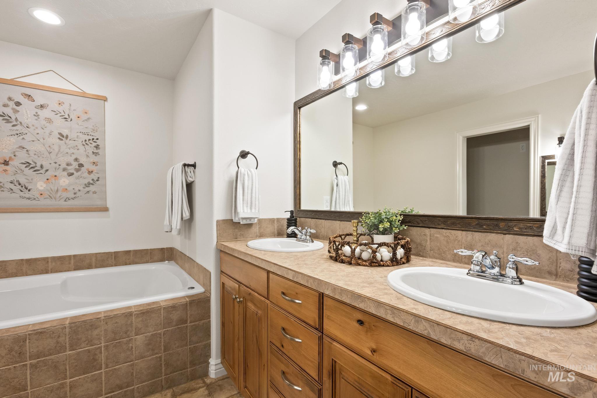 2185 Waterwheel Road Emmett, ID 83617 - Photo 23 of 49 Full bathroom featuring double vanity, a garden tub, and recessed lighting