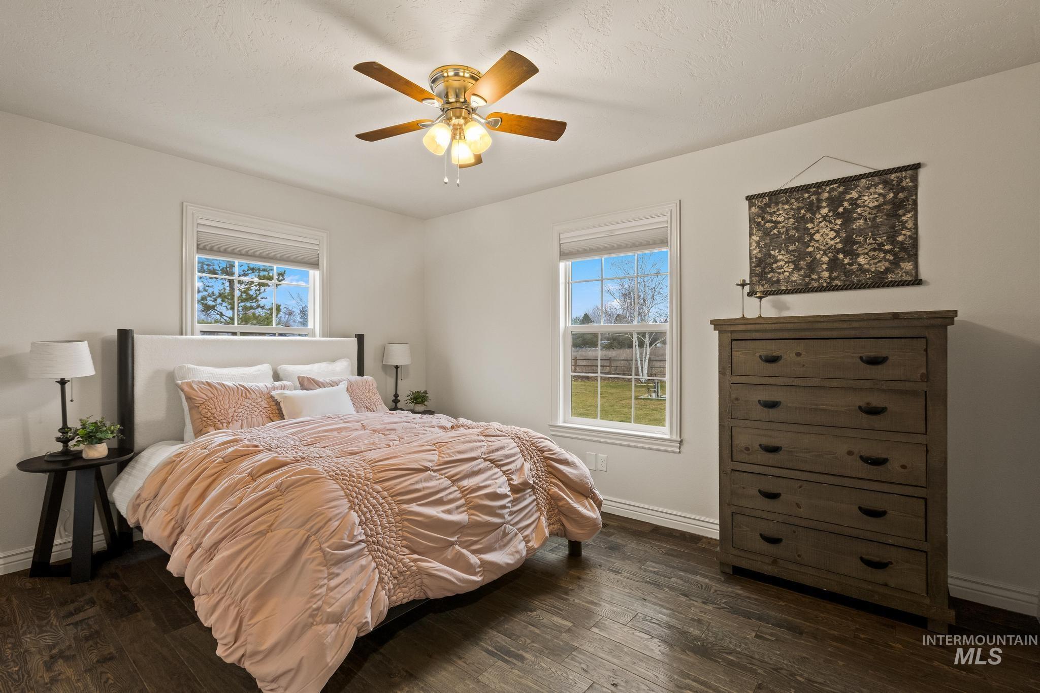 2185 Waterwheel Road Emmett, ID 83617 - Photo 30 of 49 Bedroom featuring multiple windows, dark wood-style flooring, and ceiling fan