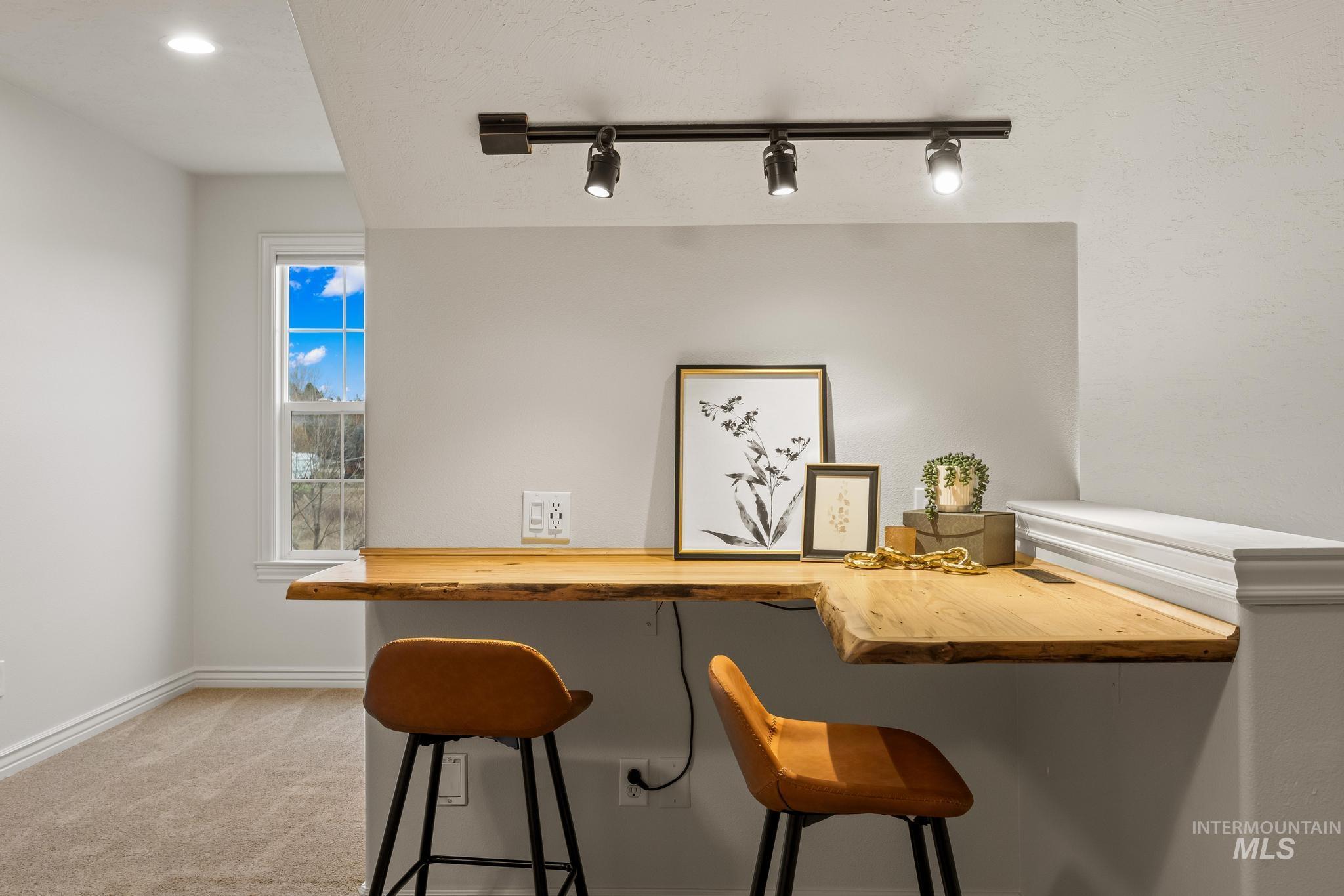 2185 Waterwheel Road Emmett, ID 83617 - Photo 33 of 49 Bar area with butcher block countertops, rail lighting, and light colored carpet