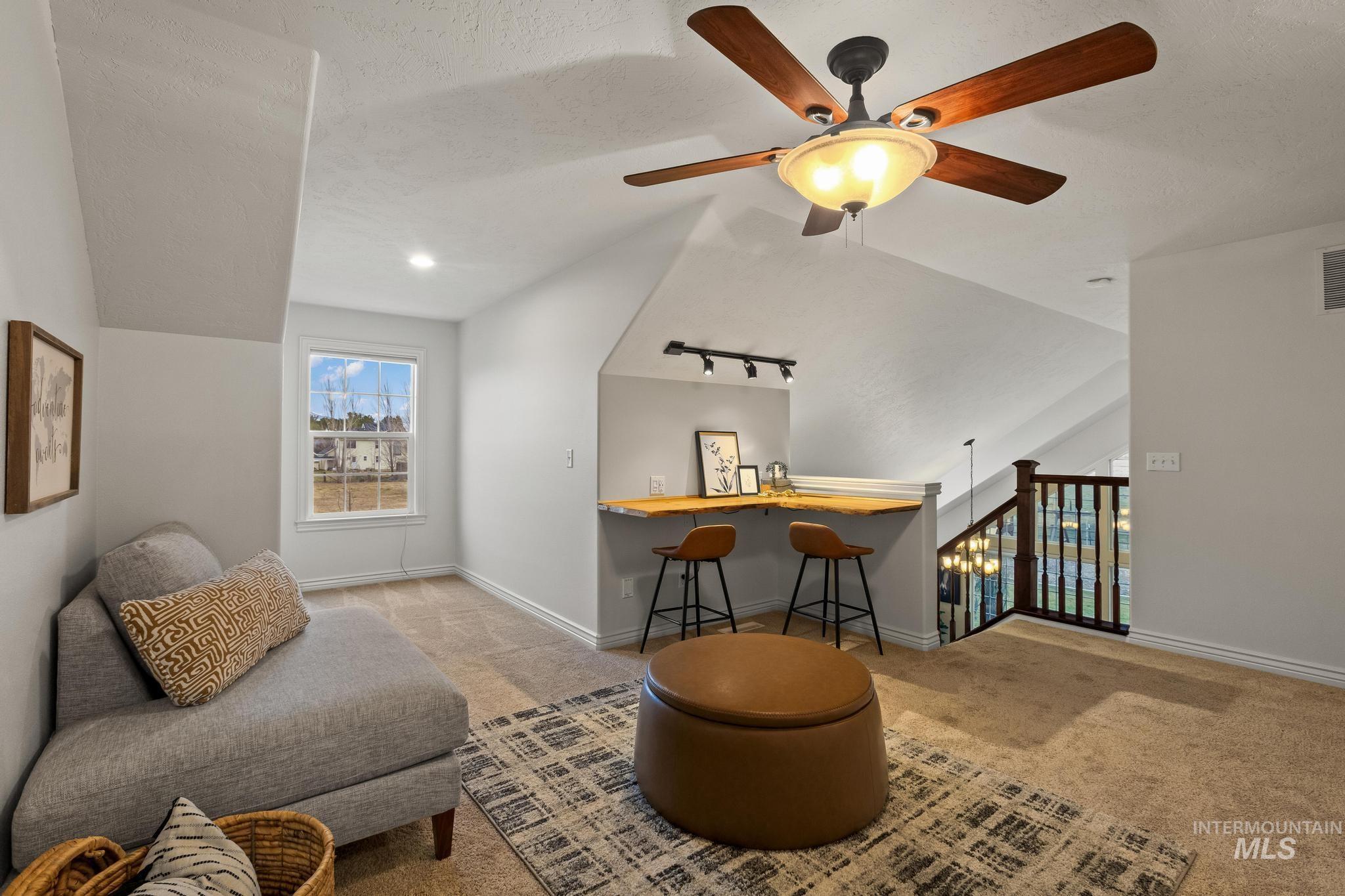 2185 Waterwheel Road Emmett, ID 83617 - Photo 35 of 49 Living area featuring light colored carpet, lofted ceiling, a ceiling fan, a textured ceiling, and rail lighting