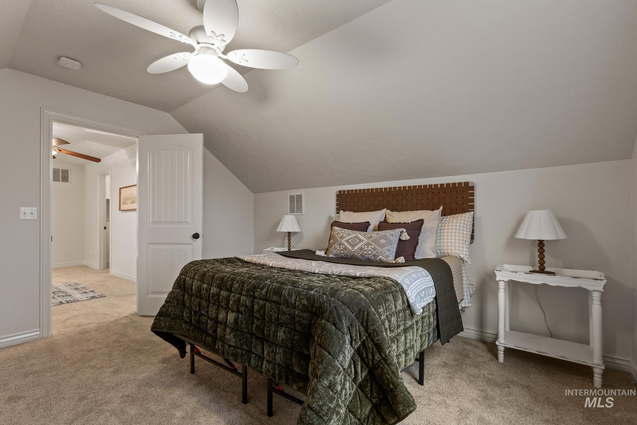 2185 Waterwheel Road Emmett, ID 83617 - Photo 36 of 49 Bedroom featuring vaulted ceiling, light colored carpet, and ceiling fan