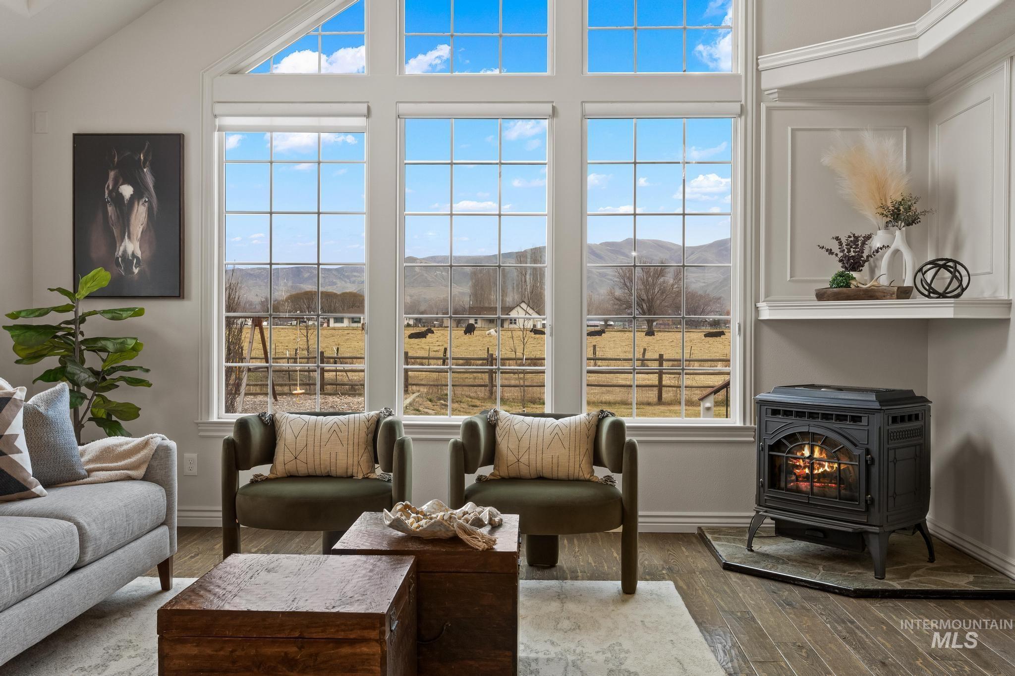 2185 Waterwheel Road Emmett, ID 83617 - Photo 4 of 49 Living room with a wood stove, plenty of natural light, and wood finished floors