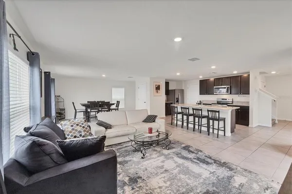 a living room with furniture and kitchen view
