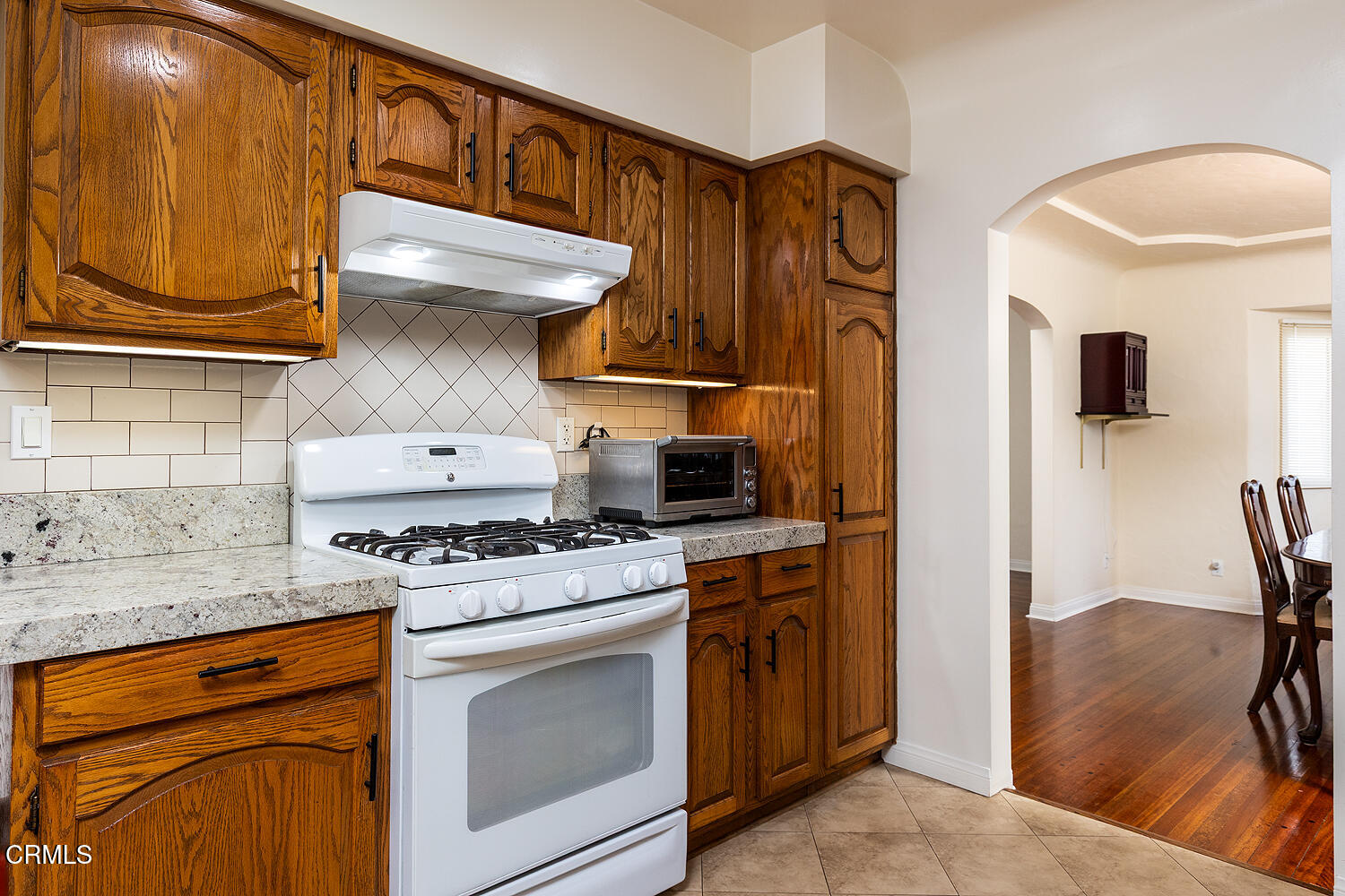 824 Palm Drive Glendale, CA 91202 - Photo 12 of 24 a kitchen with stainless steel appliances granite countertop a stove and a microwave