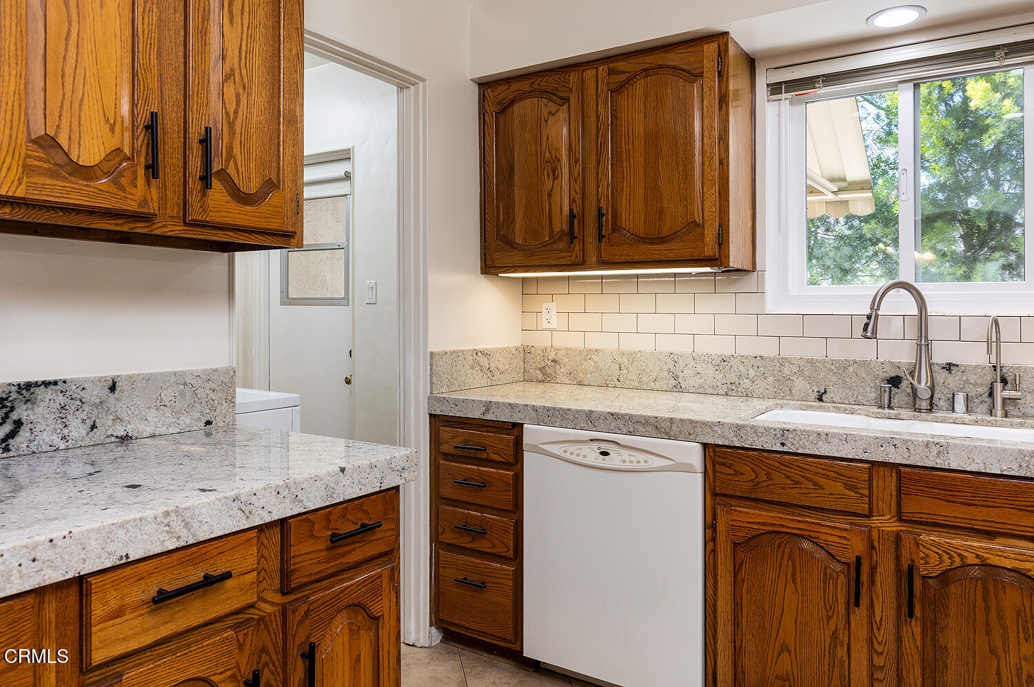 824 Palm Drive Glendale, CA 91202 - Photo 13 of 24 a kitchen with granite countertop a sink and a window
