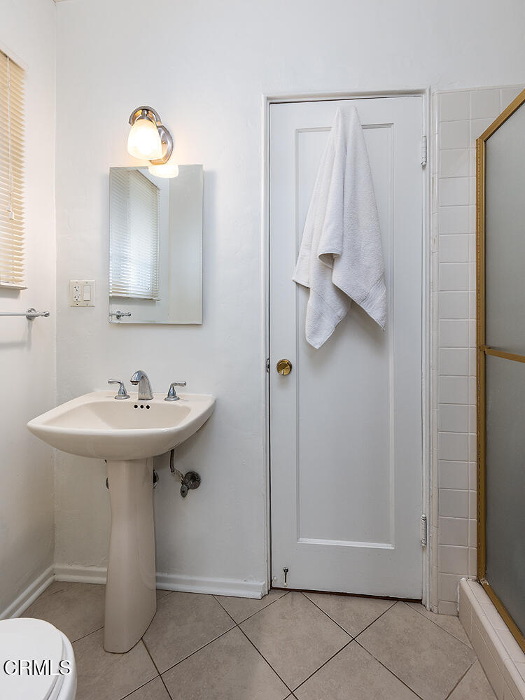 824 Palm Drive Glendale, CA 91202 - Photo 19 of 24 a bathroom with a sink a toilet and mirror