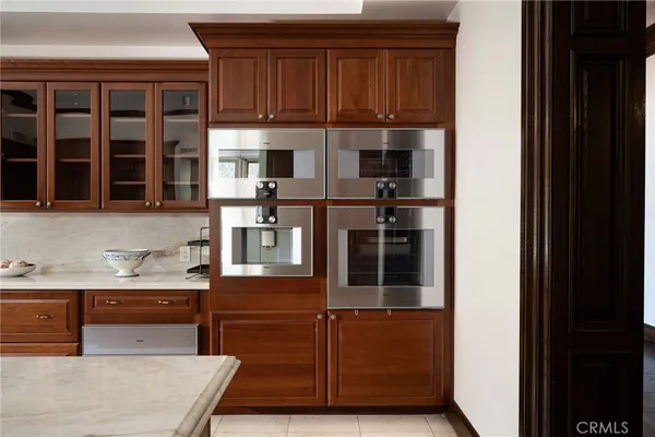 a living room with furniture and large windows
