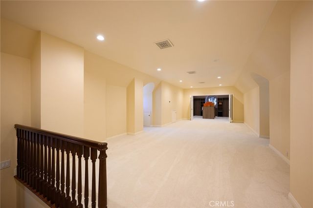 a view of a room with wooden floor and a chandelier