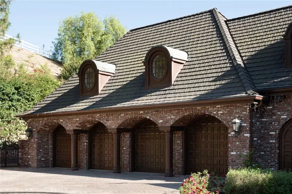 an aerial view of a house with a yard and lake view