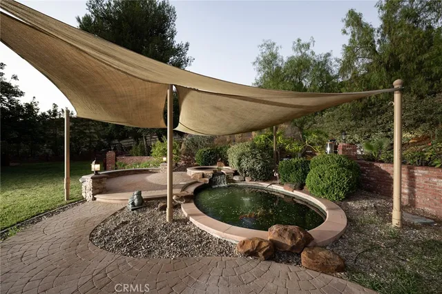 an aerial view of residential house with outdoor space and trees all around