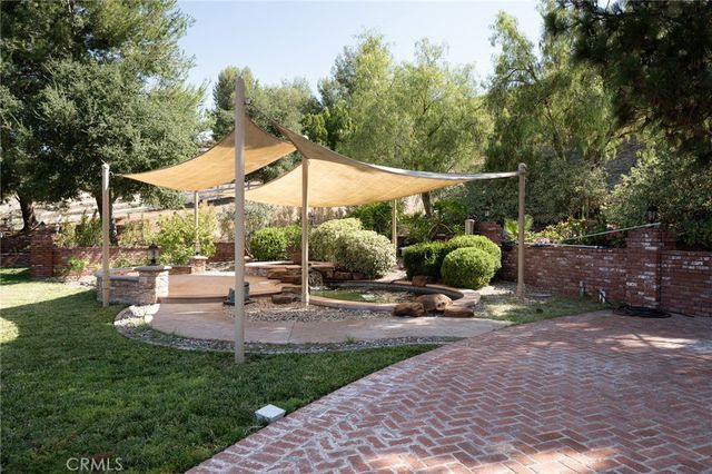 an aerial view of a house with yard swimming pool and outdoor seating