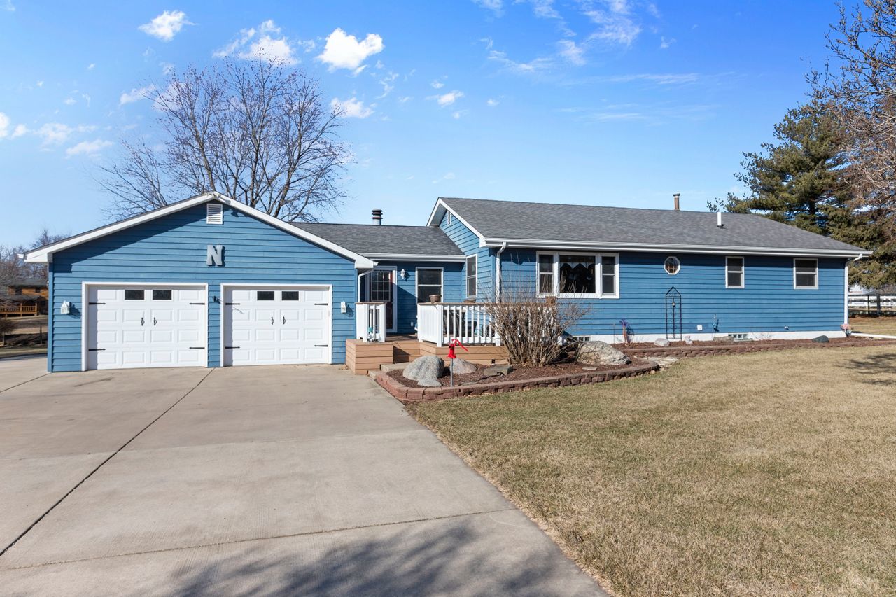 a front view of a house with garage and yard