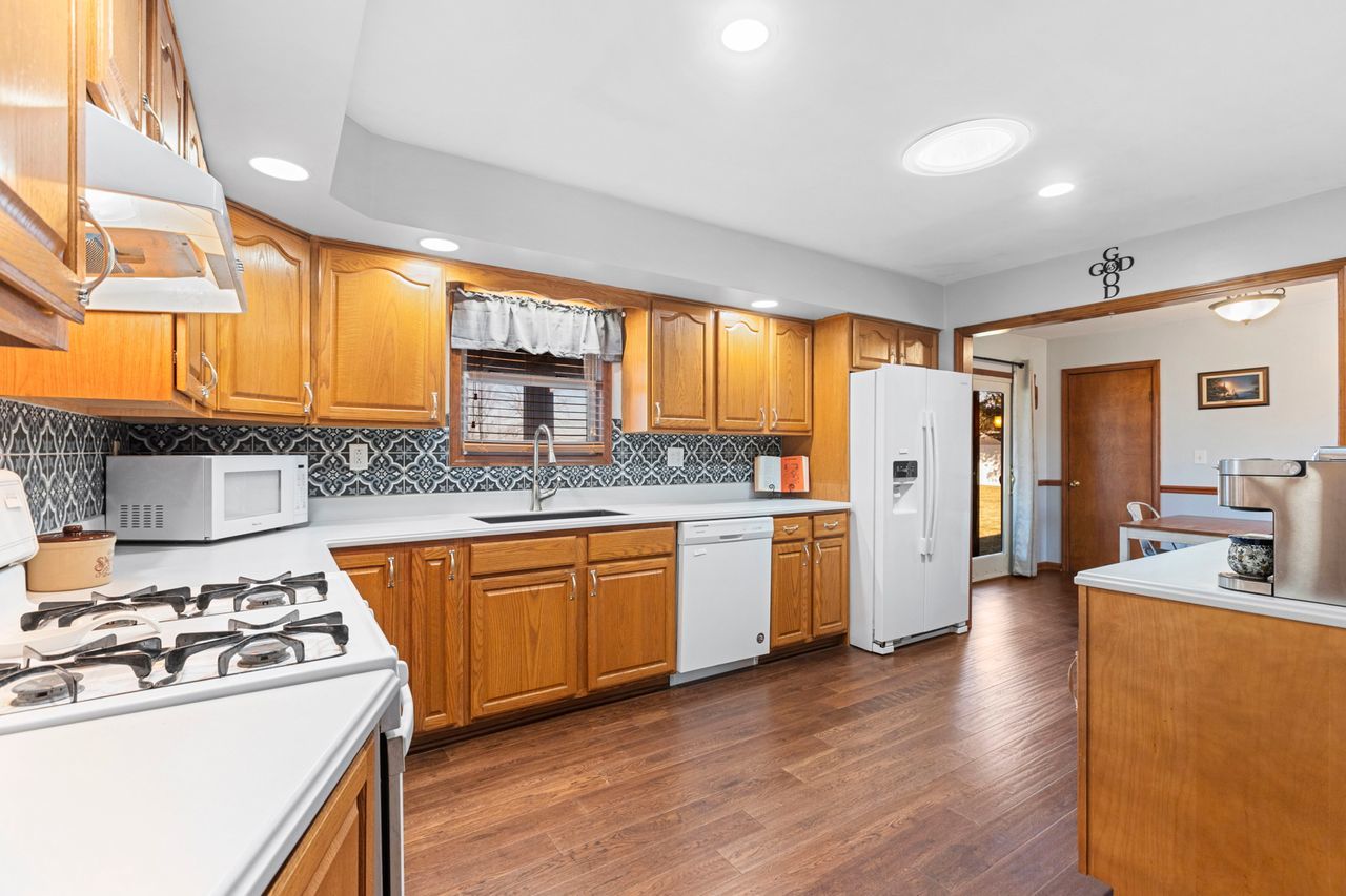 14385 Fennel Road Newark, IL 60541 - Photo 5 of 19 a kitchen with refrigerator a sink and cabinets