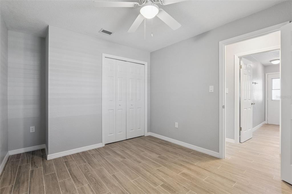 1932 Maple Circle, Unit 1932 Tavares, FL 32778 - Photo 18 of 39 wooden floor in an empty room with a window