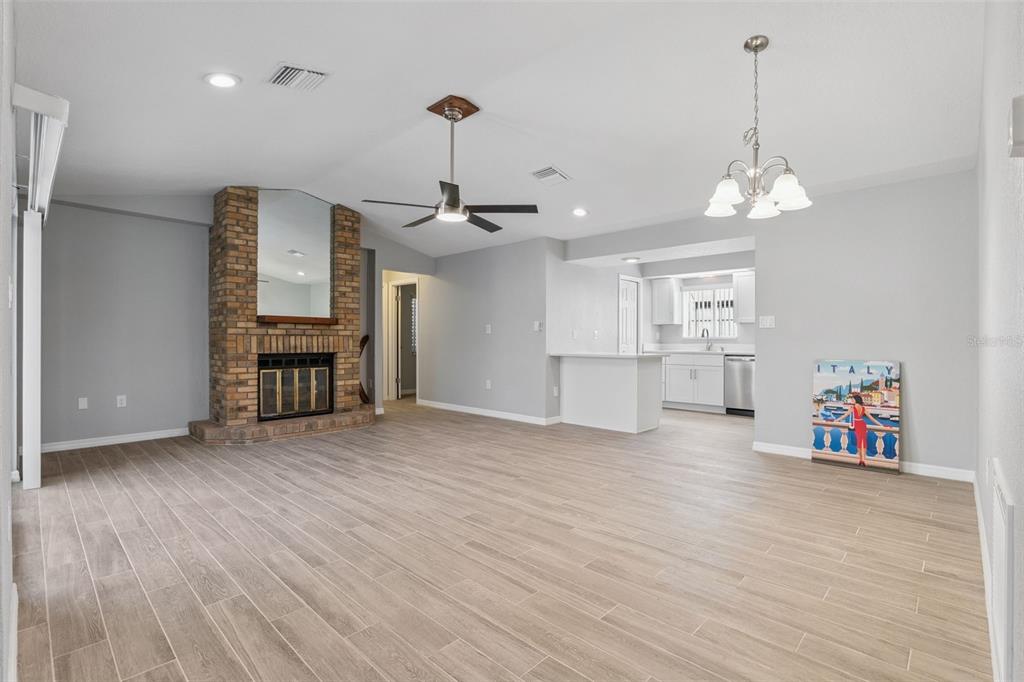 1932 Maple Circle, Unit 1932 Tavares, FL 32778 - Photo 6 of 39 a view of a room with wooden floor chandelier entryway and windows