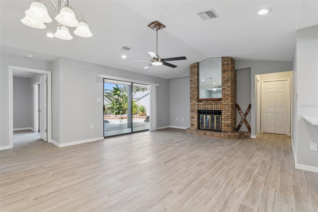 1932 Maple Circle, Unit 1932 Tavares, FL 32778 - Photo 7 of 39 a view of livingroom with hardwood floor and a ceiling fan