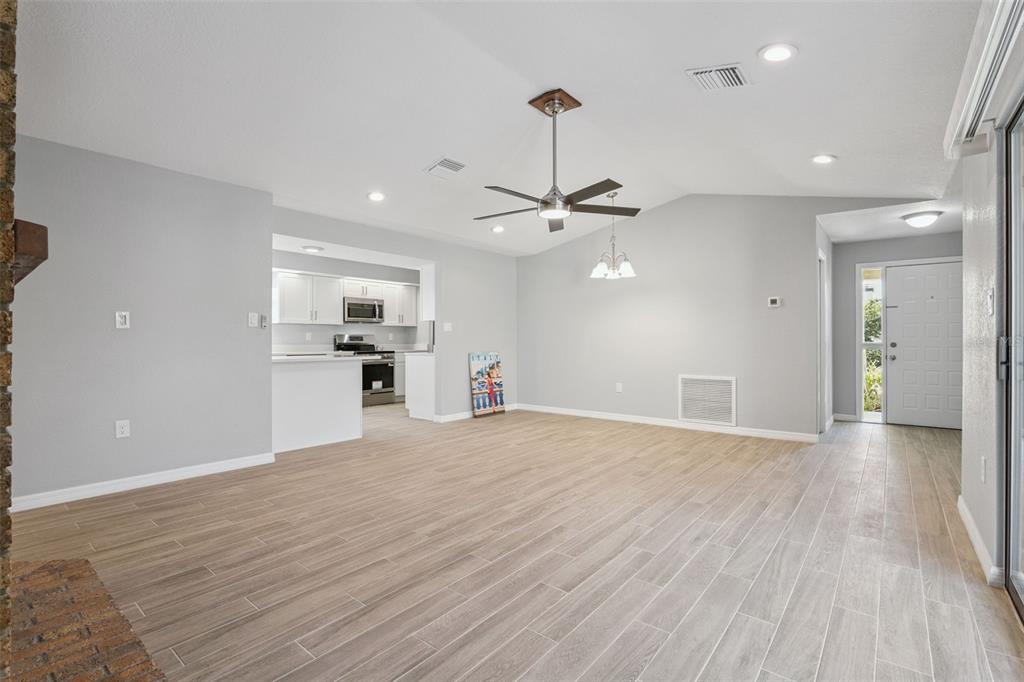1932 Maple Circle, Unit 1932 Tavares, FL 32778 - Photo 8 of 39 a view of a kitchen with a sink and dishwasher a refrigerator with wooden floor