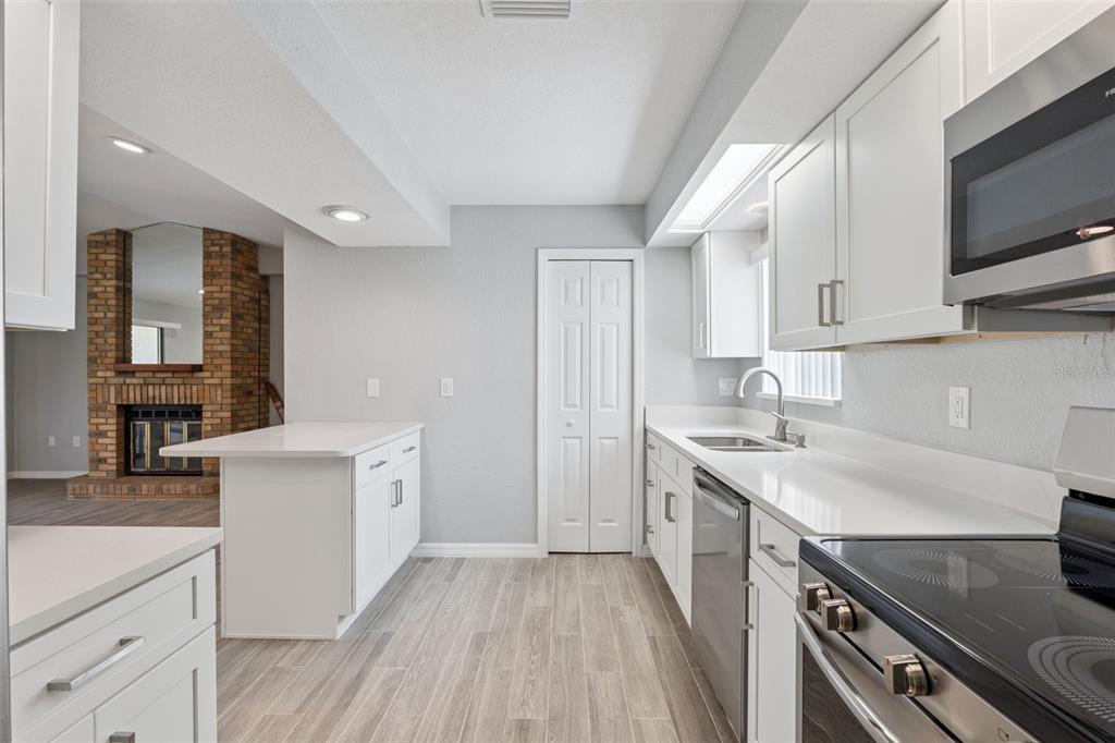 1932 Maple Circle, Unit 1932 Tavares, FL 32778 - Photo 10 of 39 a kitchen with a sink stove and cabinets