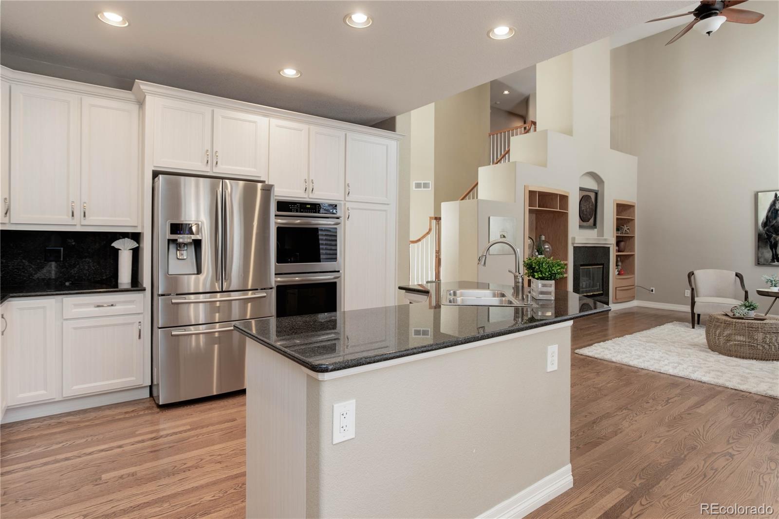 2720 Rockbridge Way Highlands Ranch, CO 80129 - Photo 14 of 39 a kitchen with stainless steel appliances granite countertop a refrigerator a stove and a sink