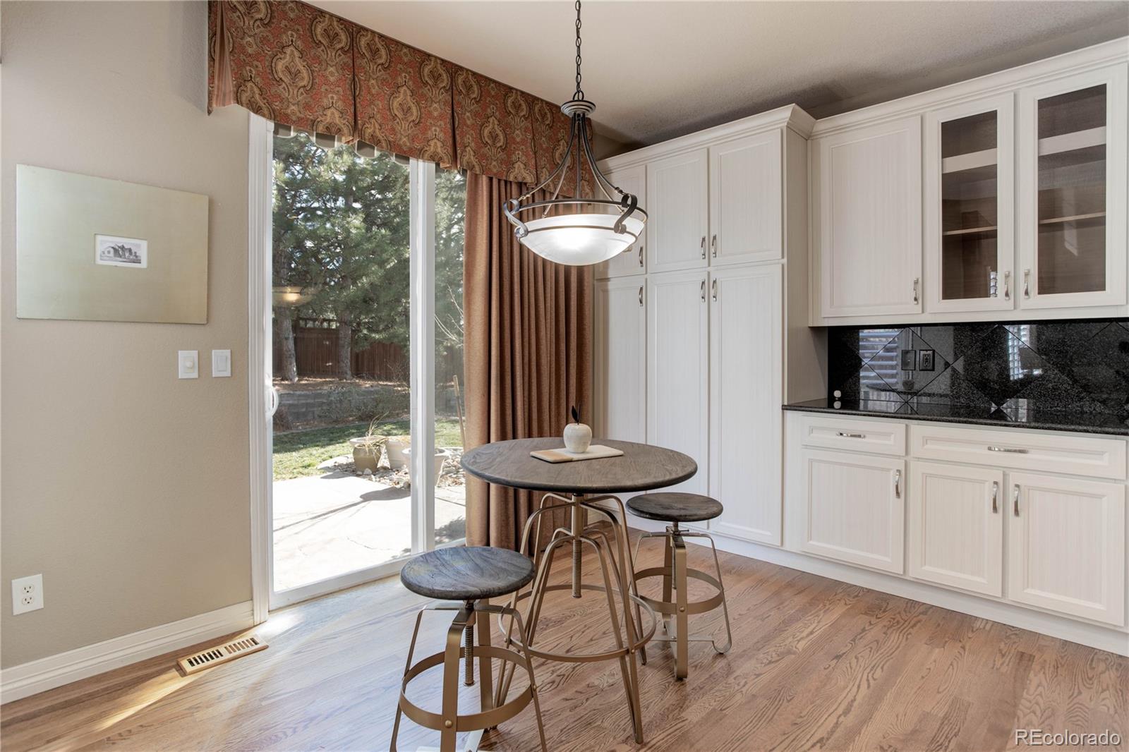2720 Rockbridge Way Highlands Ranch, CO 80129 - Photo 16 of 39 a kitchen with a table and chairs in it
