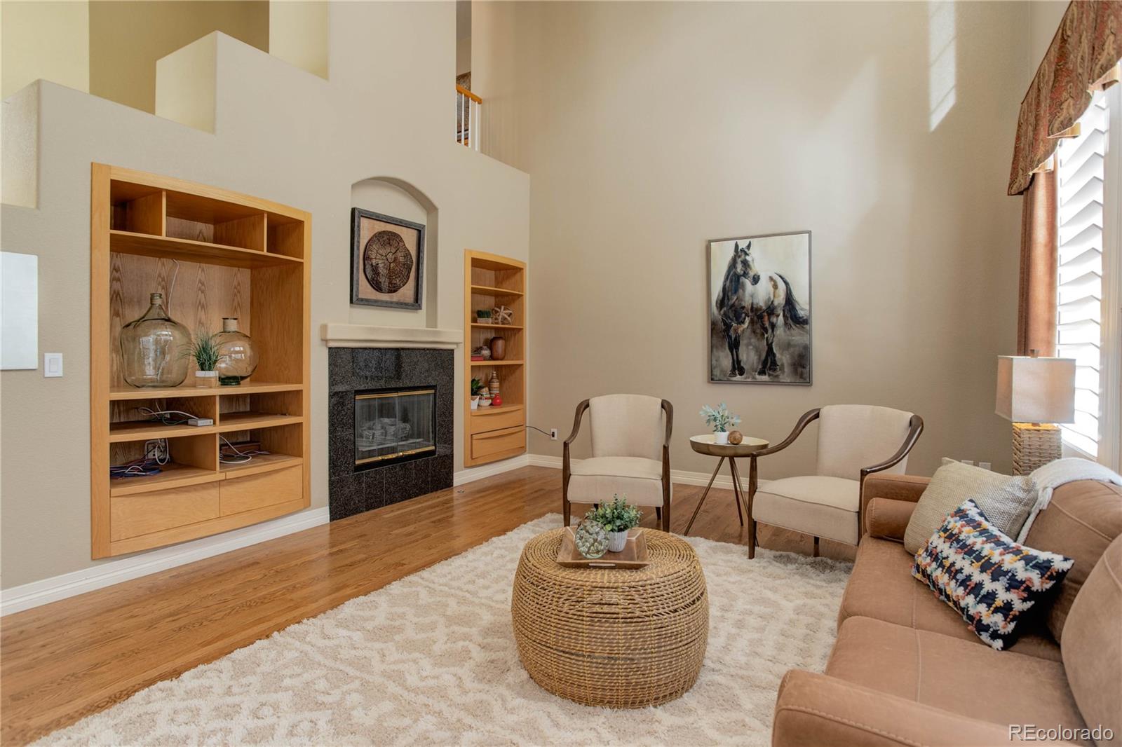 2720 Rockbridge Way Highlands Ranch, CO 80129 - Photo 17 of 39 a living room with furniture and a fireplace