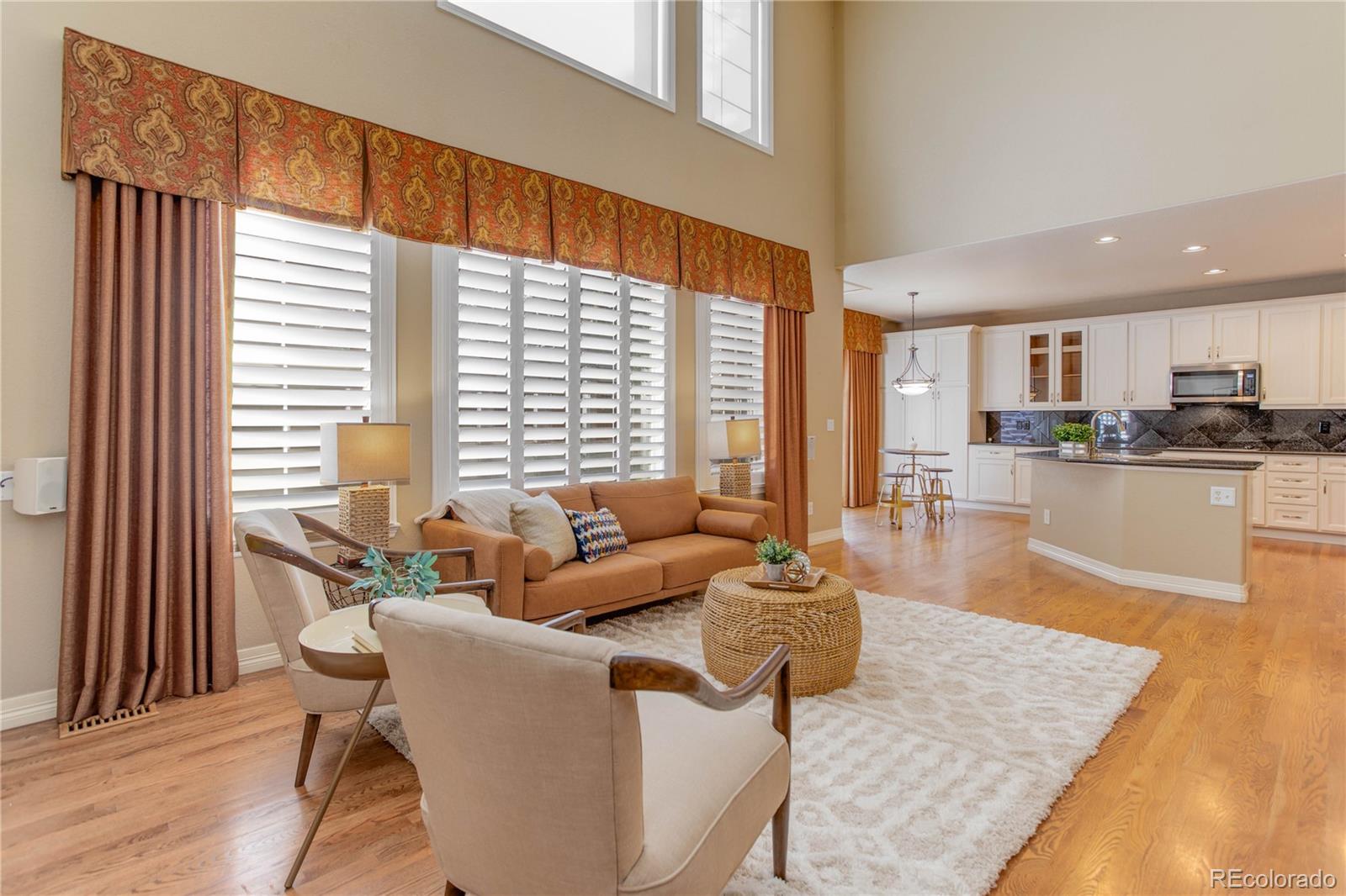 2720 Rockbridge Way Highlands Ranch, CO 80129 - Photo 18 of 39 a living room with furniture and large windows