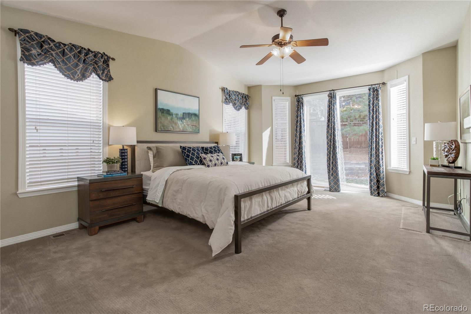 2720 Rockbridge Way Highlands Ranch, CO 80129 - Photo 19 of 39 a bedroom with a bed chandelier and a window