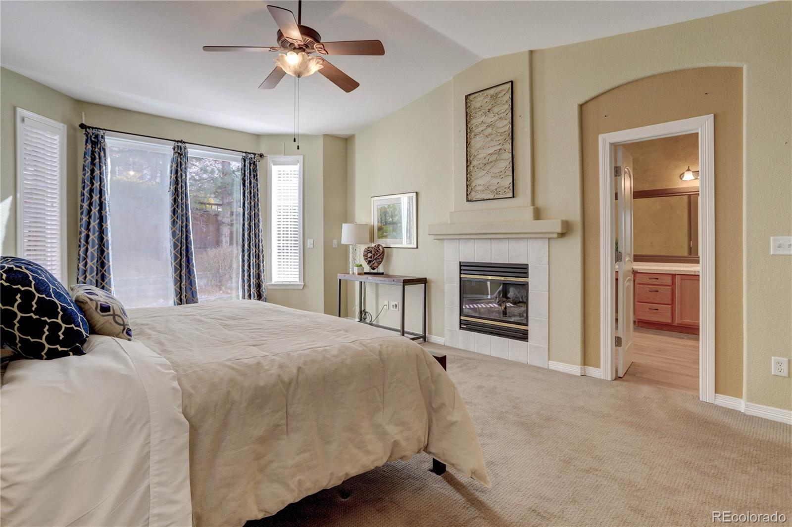 2720 Rockbridge Way Highlands Ranch, CO 80129 - Photo 20 of 39 a bedroom with a bed and a fireplace
