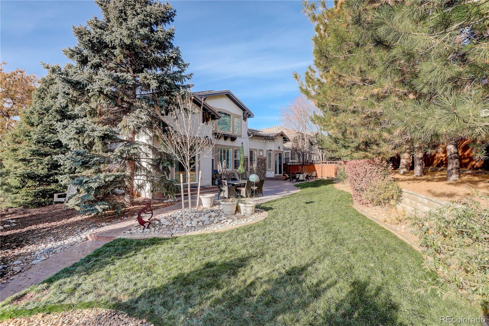 2720 Rockbridge Way Highlands Ranch, CO 80129 - Photo 2 of 39 a view of a park with swings and a fire pit