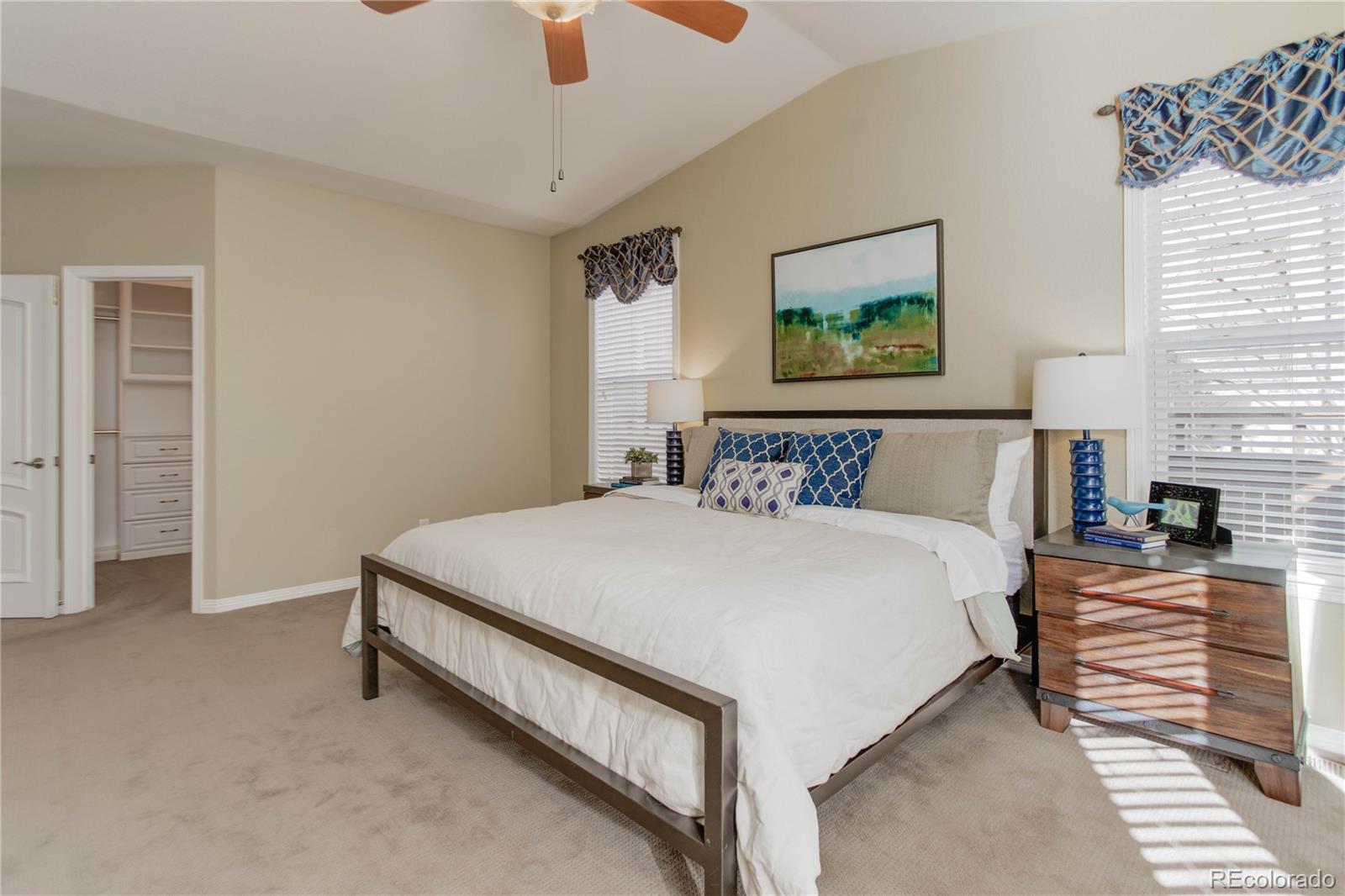 2720 Rockbridge Way Highlands Ranch, CO 80129 - Photo 21 of 39 a bedroom with a bed and a painting on the wall
